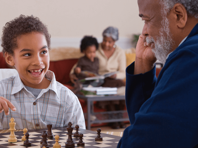 elderly man and child playing chess