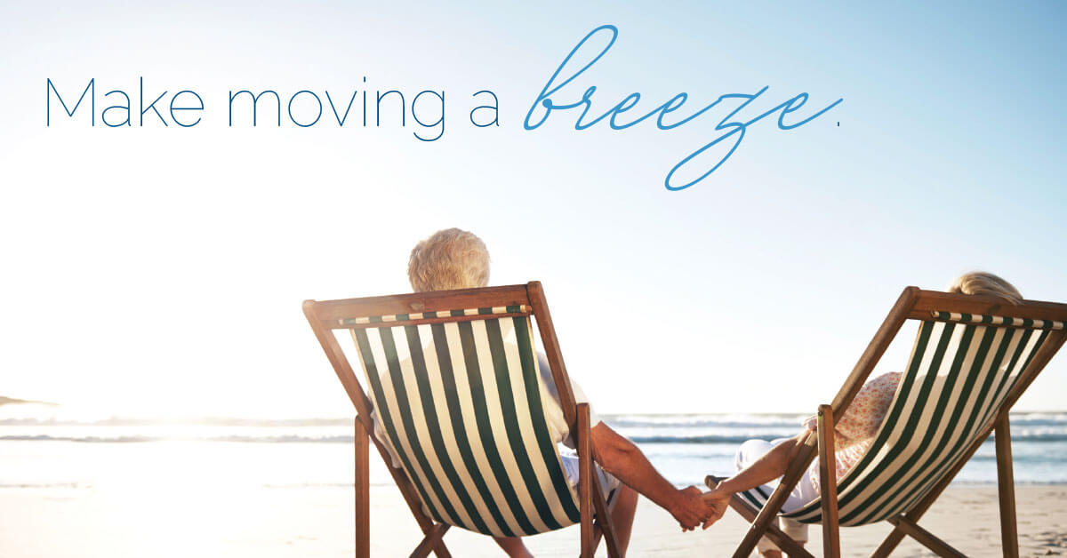 Two people holding hands in beach chairs under clear sky, with text Make moving a breeze.