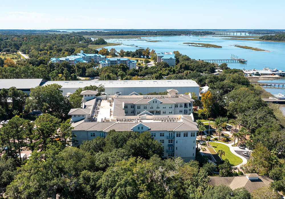 Aerial view of a senior living community with a pool and landscaped gardens.