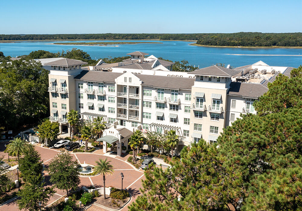 Aerial view of a senior living community by a waterfront.
