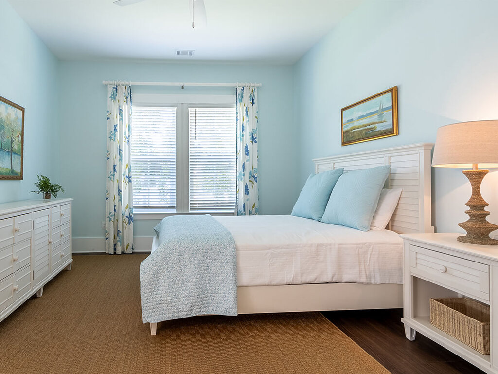 Bright bedroom in a senior unit with pastel colors and minimalist decor.